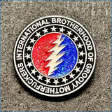 A circular enamel pin featuring the iconic red and blue lightning bolt design of the grateful dead, encircled by stars and the text ’international brotherhood of groovy motherfuckers’ on a metallic silver border.