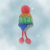 Colorful knitted hat with pom-poms on a snowy background