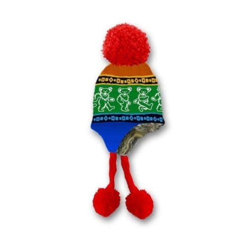 Colorful knitted dog toy with pom-poms on a white background