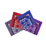 Three colorful playing card boxes stacked on a white background
